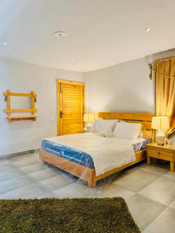 a bedroom with a large bed in a room at Granny's Den - Nathia Gali in Nathia Gali