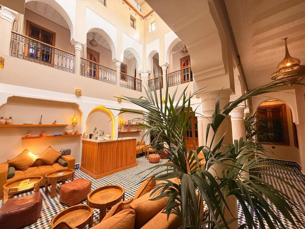 a large living room with a couch and a table at Riad Zaki Marrakech in Marrakesh
