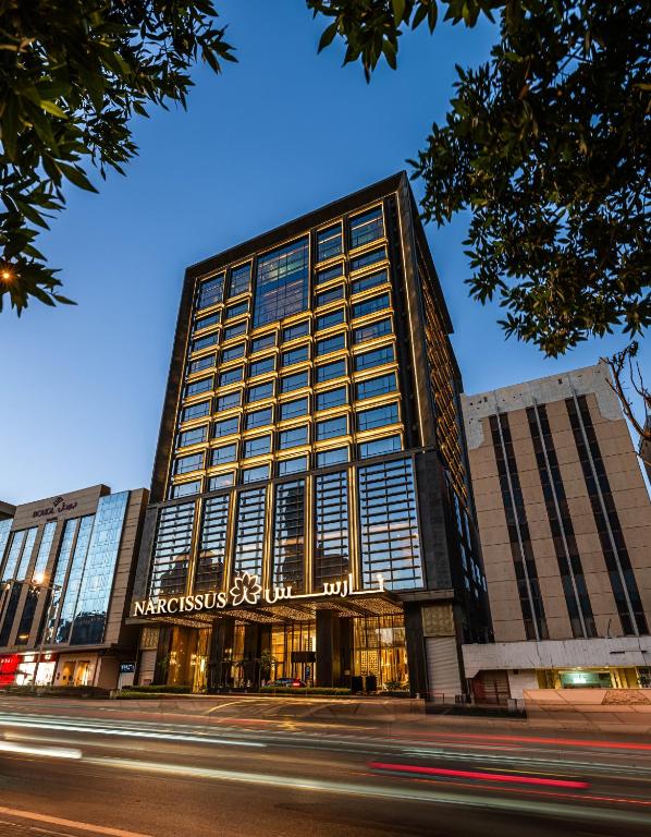 a building on a street with a street at Narcissus The Royal Hotel in Riyadh