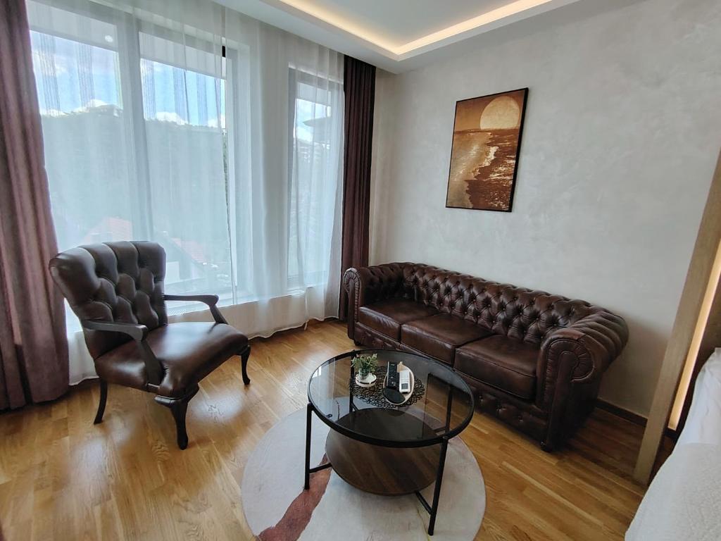 a living room with a couch and a chair and a table at CENTRAL SQUARE - Apartmani Centar Zlatibor in Zlatibor