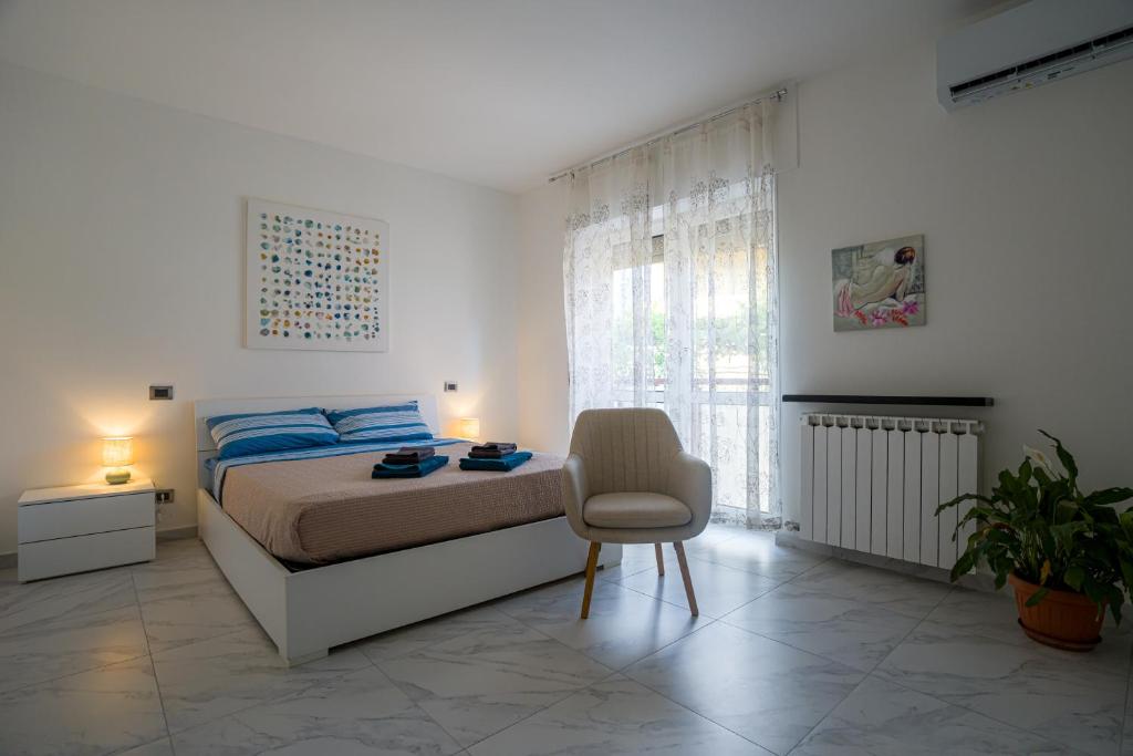 a bedroom with a bed and a chair in it at Ca' di Sara in Domodossola