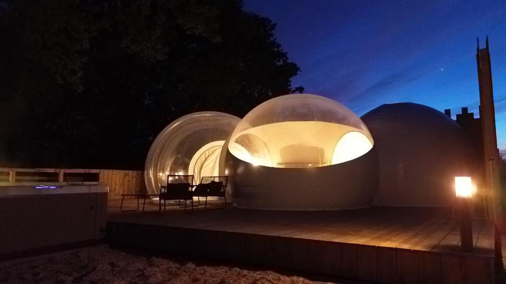 two glass domes on a building at night at La Bulle des Brosses étoilées in Igé