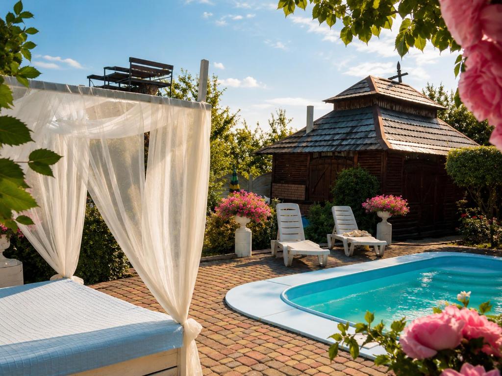 a backyard with a bed and a swimming pool at Vip Sadyba Svalyava in Svalyava