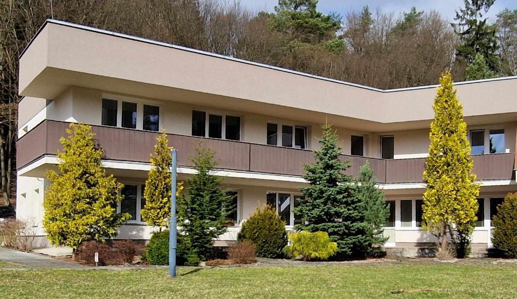 a building with trees in front of it at Apartmán Všemina 346 in Všemina