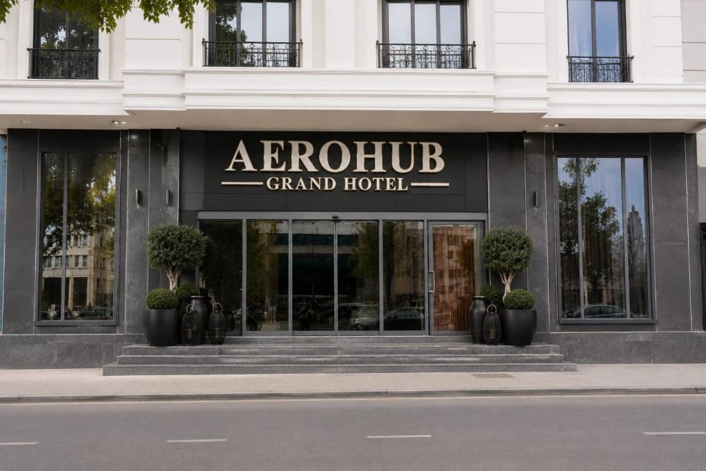 a grand hotel with a sign on the front of a building at Aerohub Grand Hotel in Arnavutköy