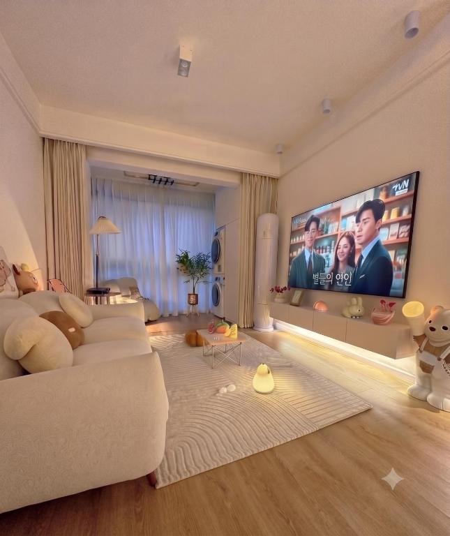 a living room with a large flat screen tv at Luxury apartment With 3 Ac and Free Parking in Lahore