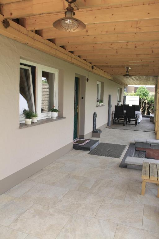 a porch with a wooden ceiling and a patio at Ferienwohnung Moin Eifel in Schleiden