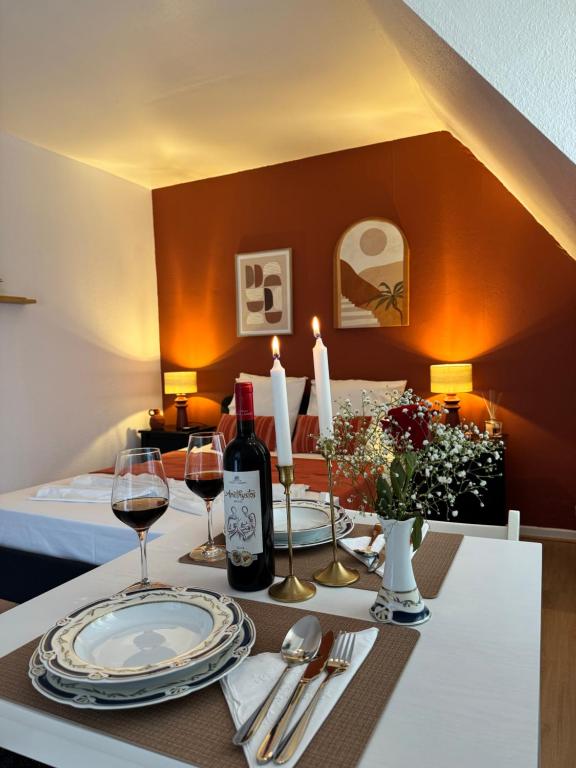 a table with wine glasses and wine bottles on it at Studio Centre Strasbourg in Strasbourg