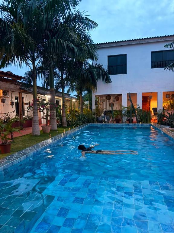 a woman laying in a swimming pool at a hotel at VILLA Fleurie in Mafia
