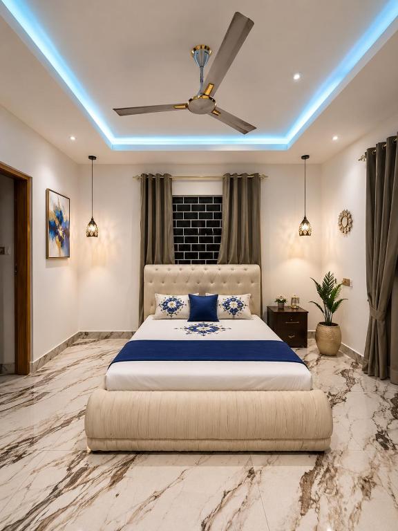 a bedroom with a large bed with blue lighting at Good Deeds Realty in Elmina