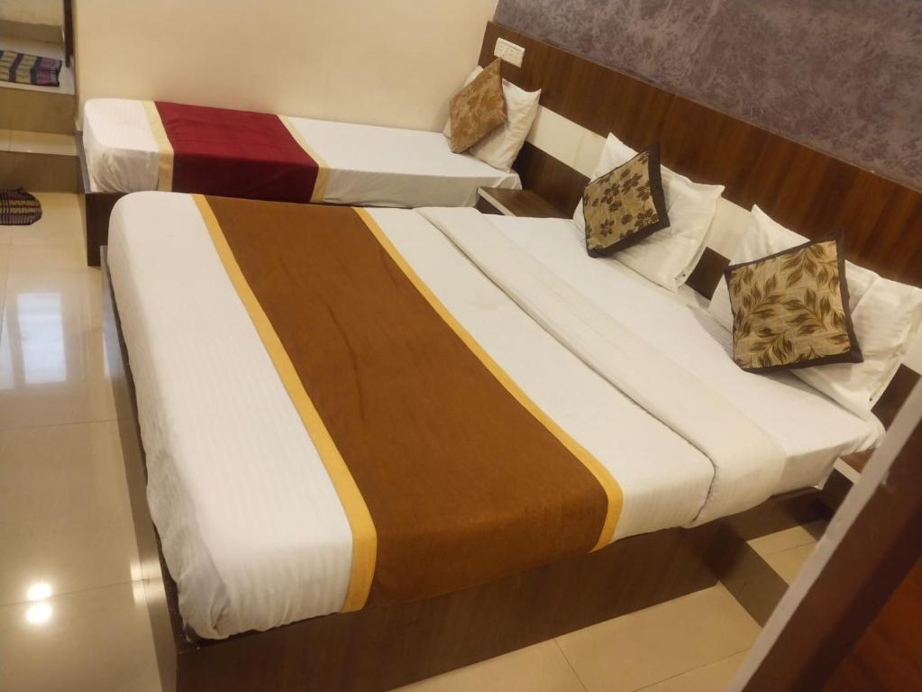 two beds in a hotel room at AA Grand in Hyderabad