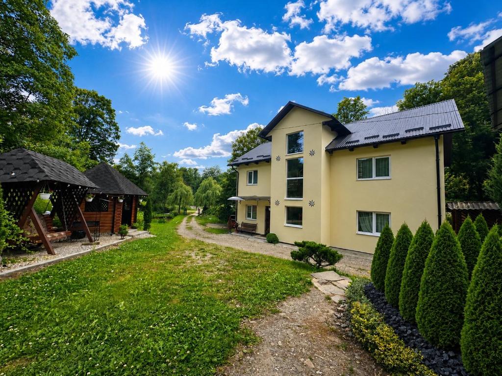 a house in a yard with a pathway at Edelweiss in Lazeshchyna
