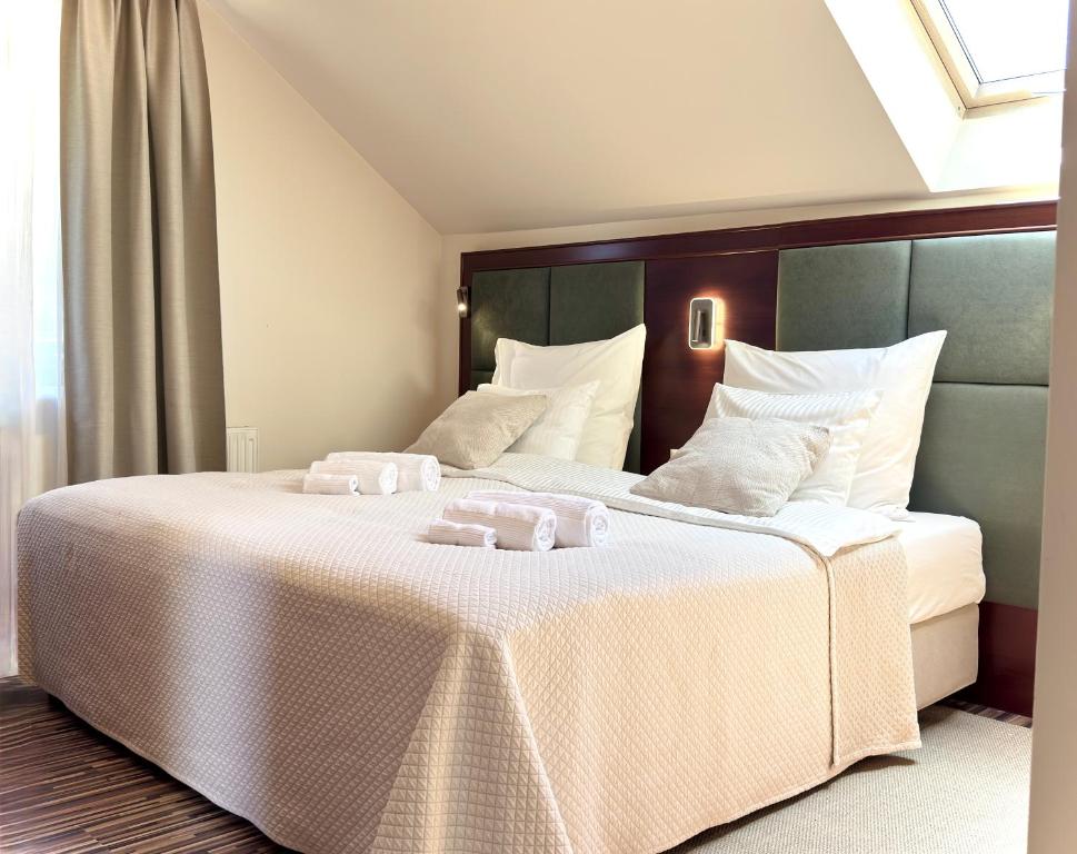 a bedroom with a large bed with two towels on it at Willa RIVA in Wisła