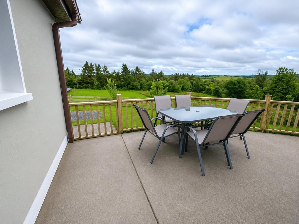 a patio with a table and chairs on a balcony at Hill house Westport in Castlebar