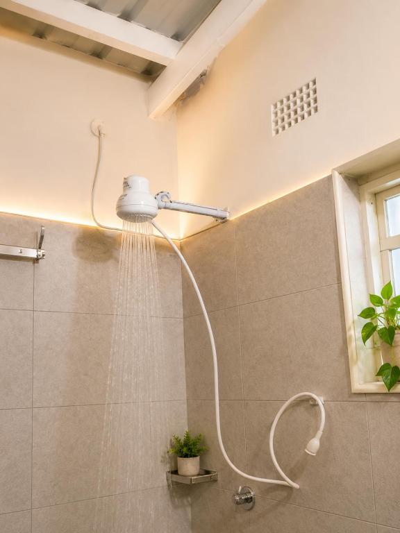 a shower with a shower head in a bathroom at UV Apartment in Lilongwe