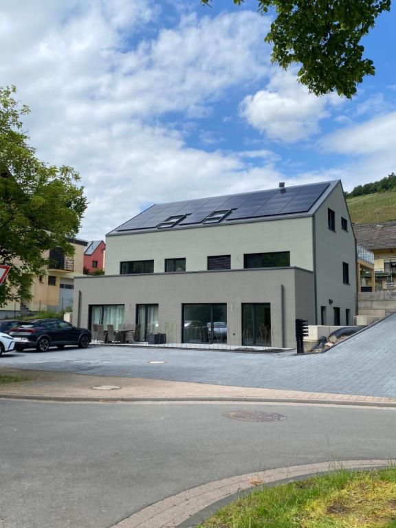 a large white building with solar panels on it at Hedwig und Paul in Mehring