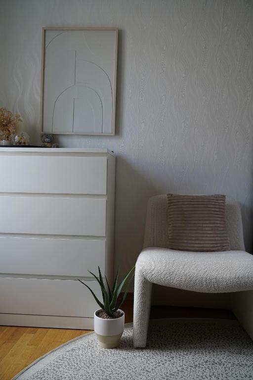 a living room with a chair and a dresser at Titanium in Izola