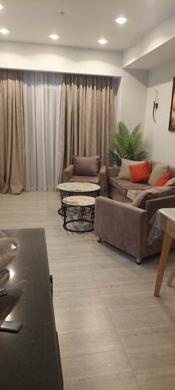 a living room with two couches and a table at Apartament Tbilisi in Tbilisi City