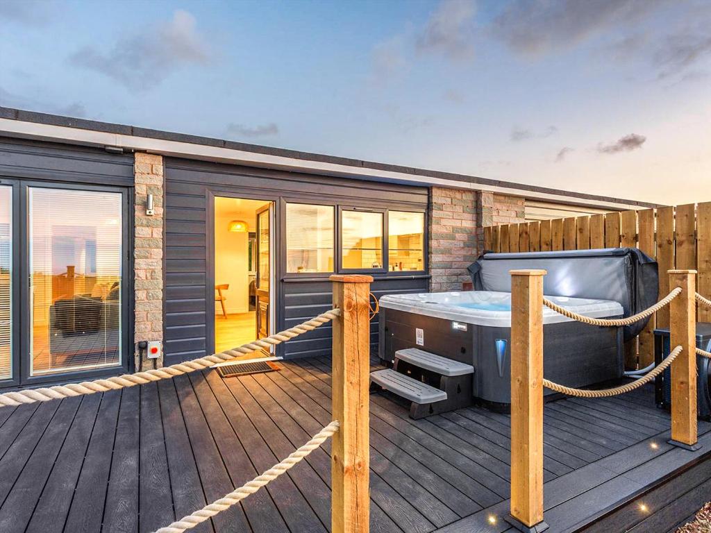 a deck with a hot tub on a house at 178 Residences - Ukc8998 in Ilfracombe