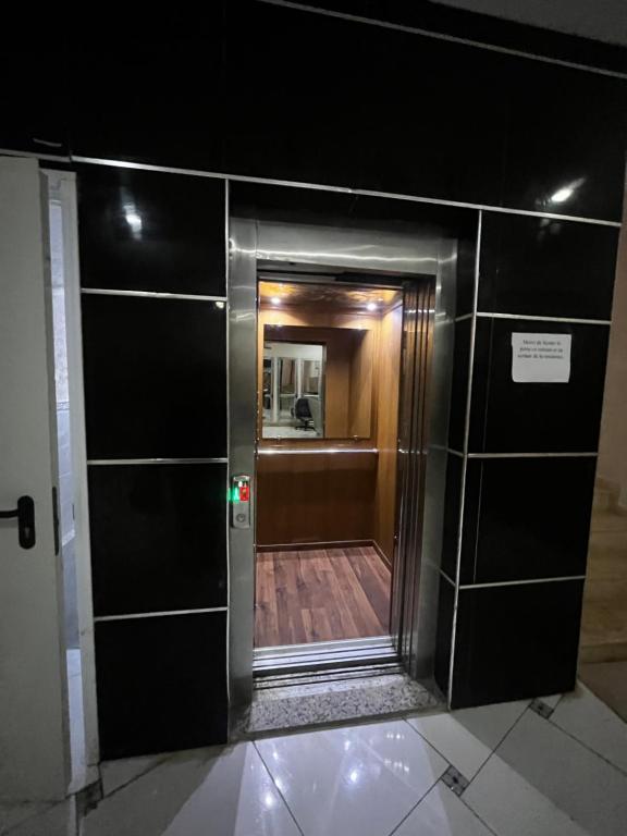a view of a hallway from inside a elevator at Spacious and sunny comfy apartment in Oran