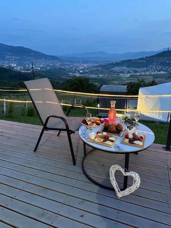 a table with a tray of food on a deck at Džipsi glamping resort in Sarajevo