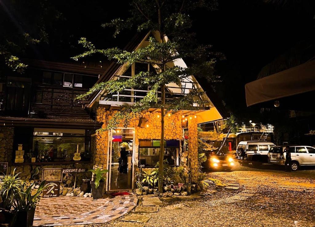 a building with a person standing outside of it at night at Sikatel Hotel in Batac