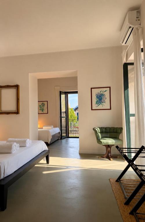 a bedroom with a bed and a chair at Nice Sea Suite in Salerno