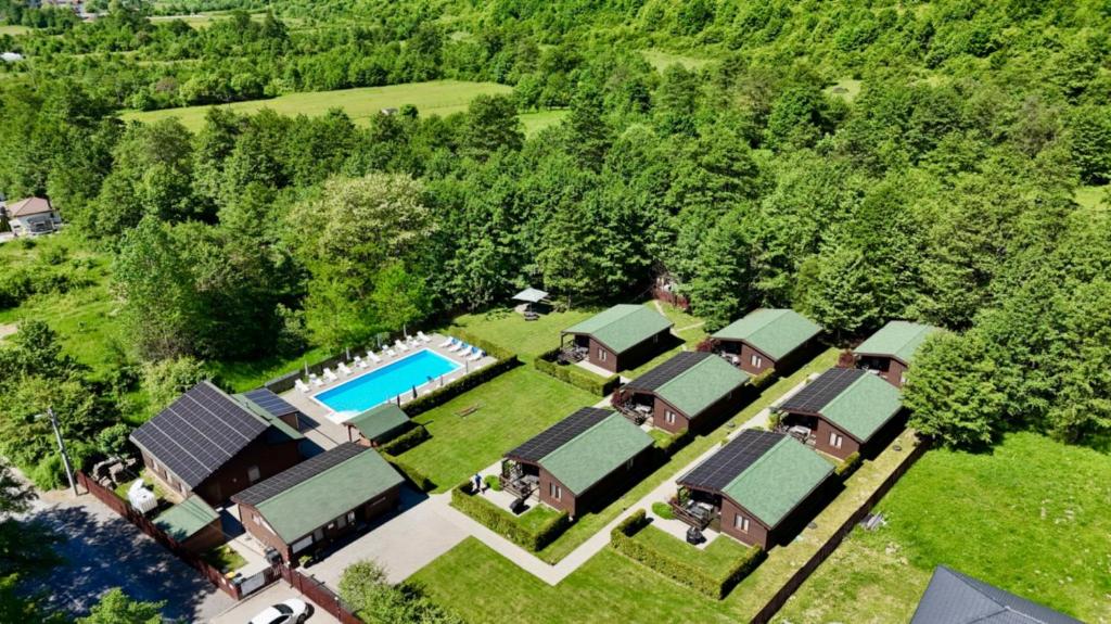 an aerial view of a resort with a pool and trees at Kalabash Apartments in Sovata
