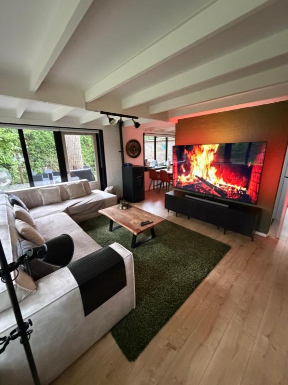 a living room with a couch and a fireplace at Vakantiehuis Lanaken in Lanaken