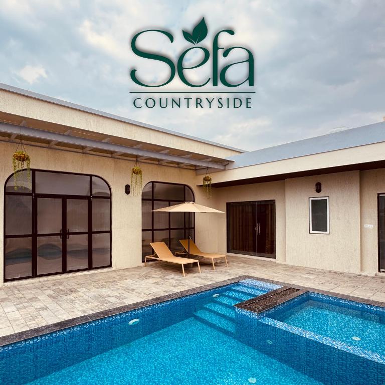 a swimming pool in front of a building at Sefa Countryside in Sukhi Sewānia