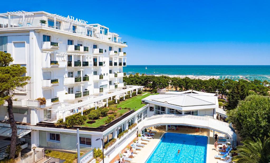an aerial view of a hotel with a swimming pool and the ocean at Atlantic Hotel & SPA in Riccione