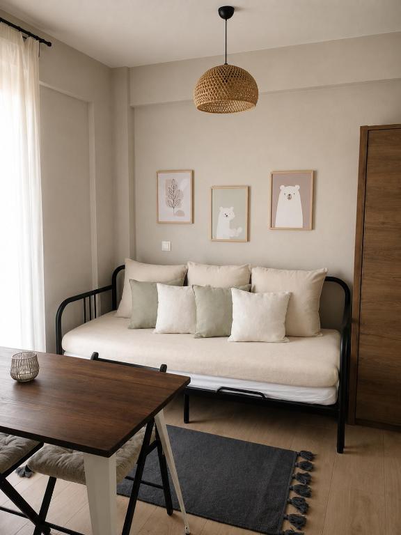 a living room with a couch and a table at Friends' Place Trikala in Tríkala