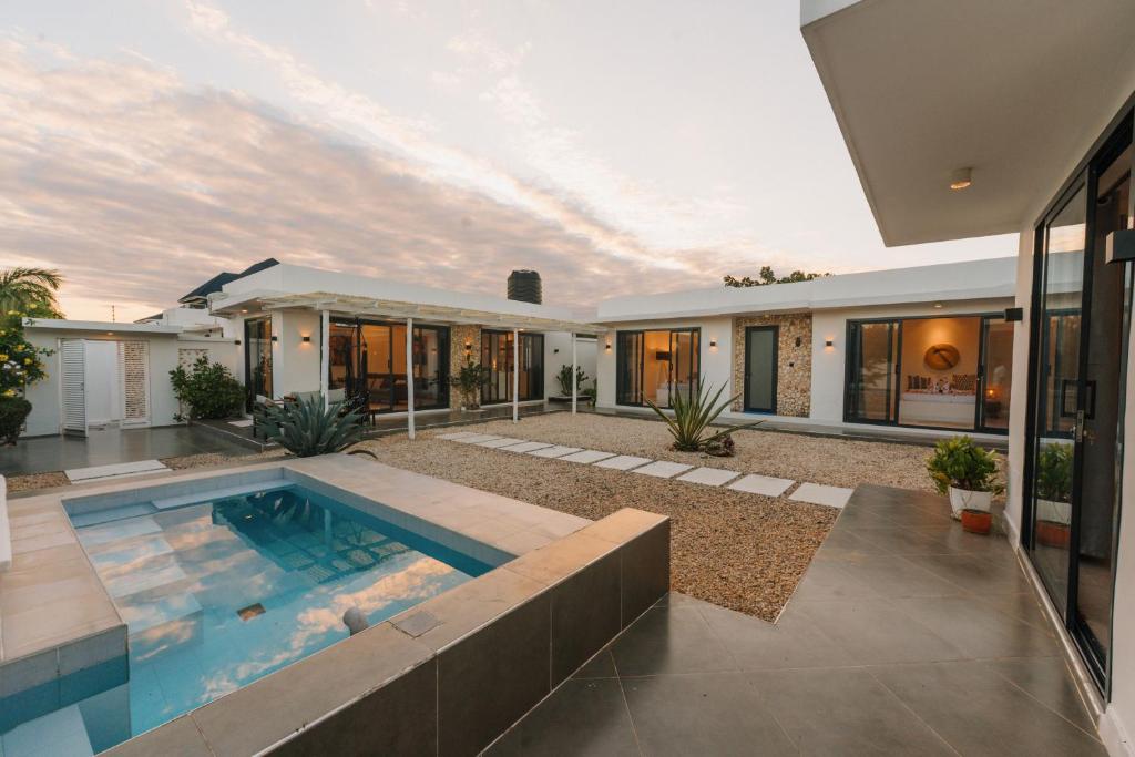 a house with a swimming pool in the yard at Casa Blanca Bweleo in Bweleo