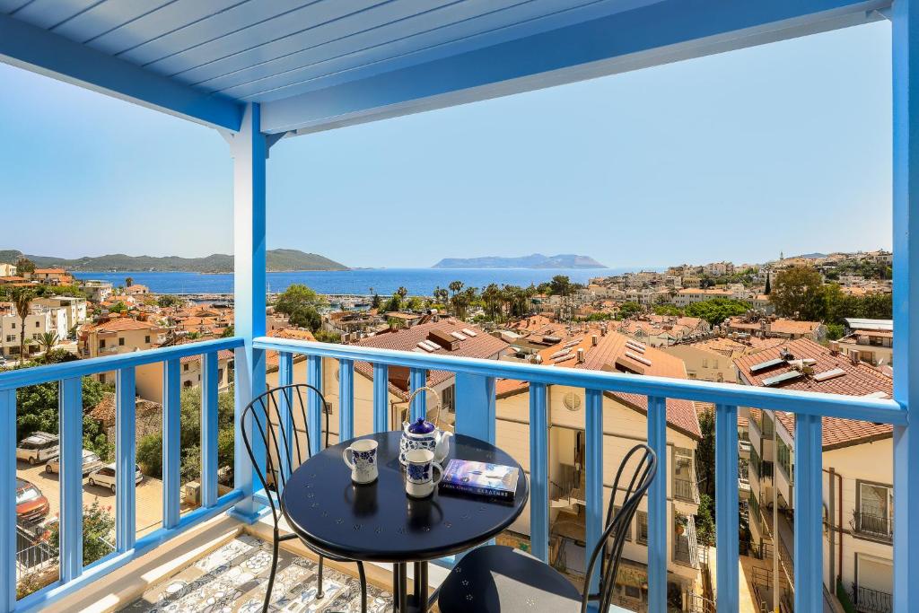 a balcony with a table and chairs and a view at Mavi Kıyı Suites in Kaş