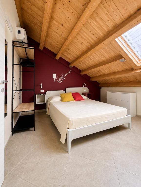 a bedroom with a bed and a wooden ceiling at Casa Vacanze Guccini in Porticello