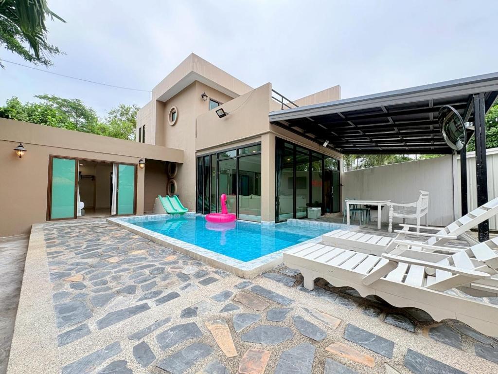 a house with a swimming pool in front of a house at A1-Mountain View Private Pool Villa-บางแสน in Chon Buri
