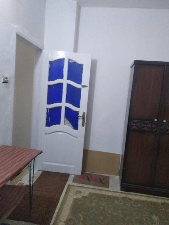 a room with a door with blue stickers on it at Fadi house in Abū Kabīr