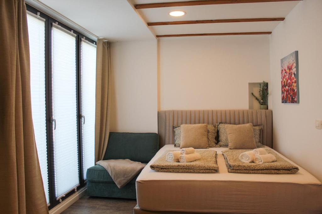a bedroom with a bed with towels on it at Studio Henigman in Dolenja Vas