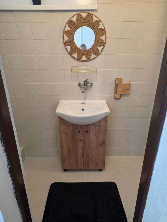 a bathroom with a sink and a mirror at Salem apartmany in Radava