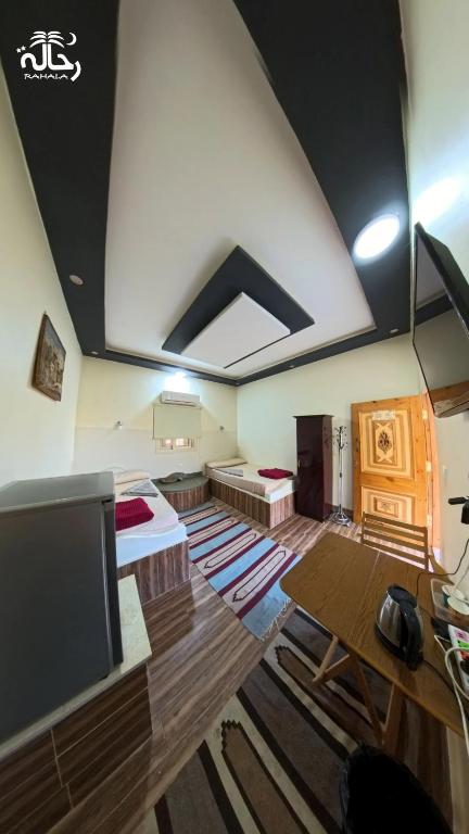 a living room with a large room with a ceiling at Rahala Safari Hotel in Qasr Al Farafirah