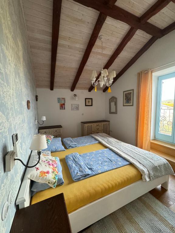 a bedroom with two beds and a window at Krk Houses in Kornić