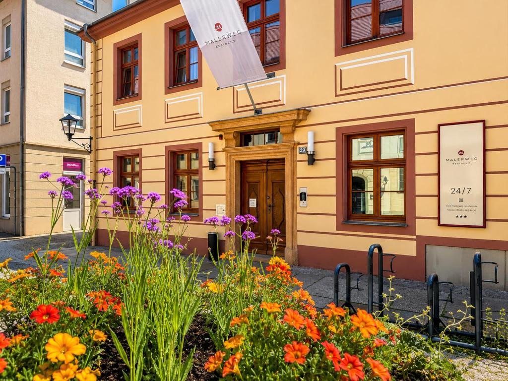 a building with flowers in front of it at Malerweg Residenz in Pirna
