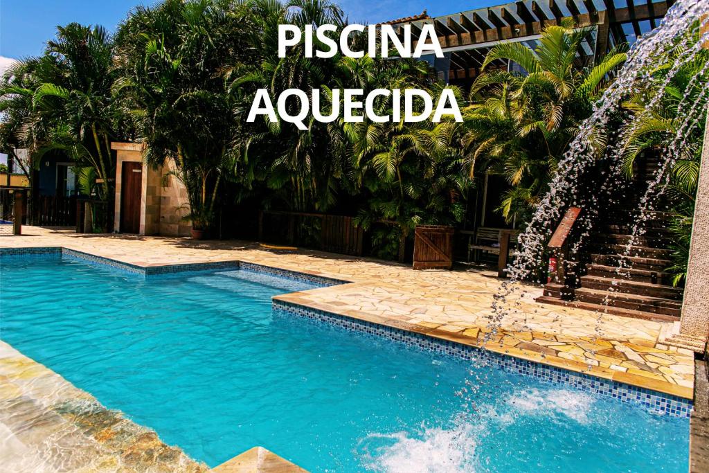 a swimming pool with a water fountain at Pousada La Dolce Vita in Búzios