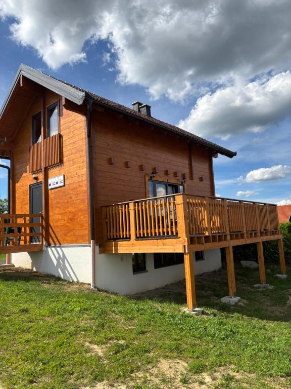 a house with a large deck on the side of it at Apartman Andrej in Kolarec