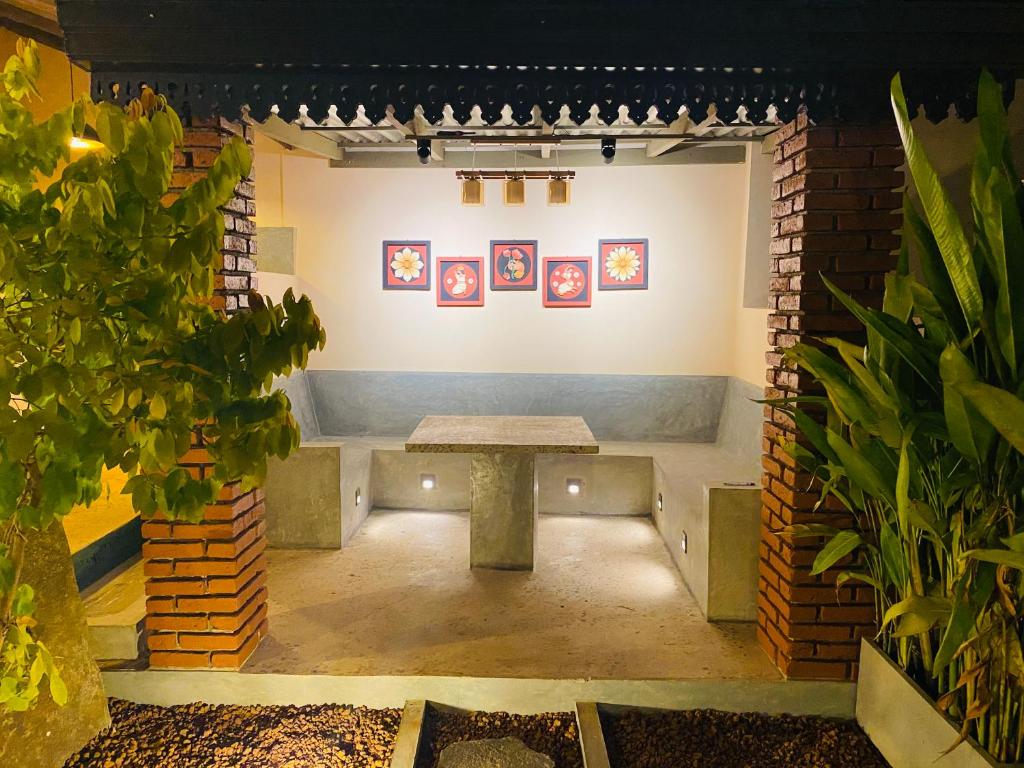 a room with a table and pictures on the wall at Thisu Villa in Dickwella
