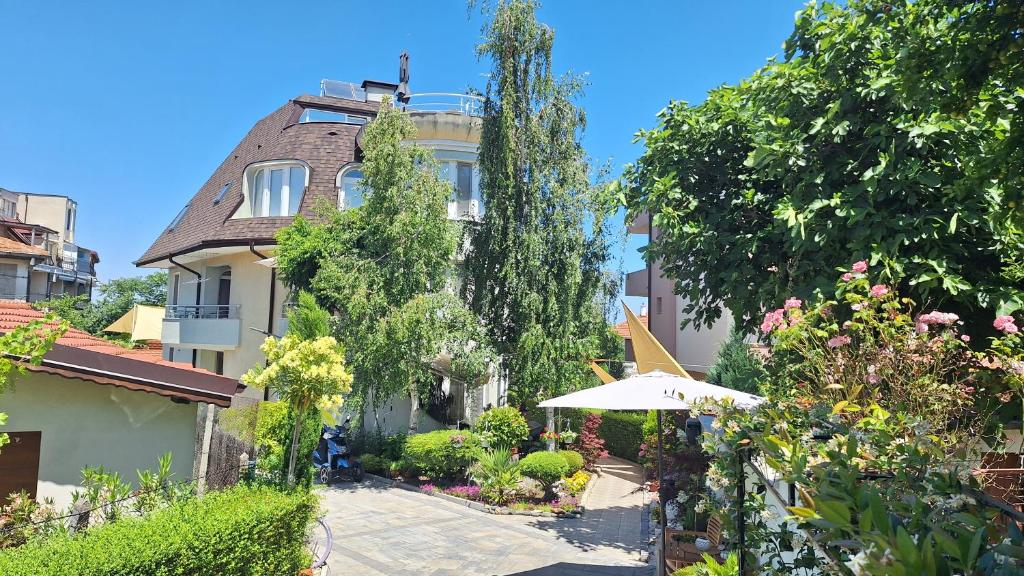 a building with an umbrella in front of it at Dimana in Chernomorets