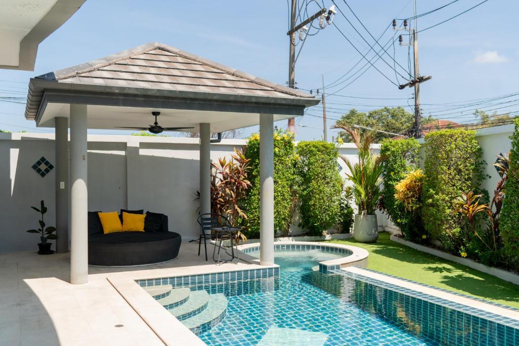 a gazebo with a pool in a backyard at Luxury 4 Bedroom Beach House in Ban Saiyuan (1)