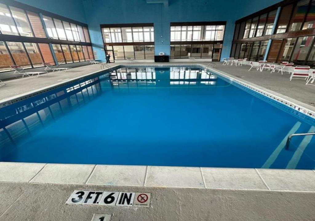 a large pool with blue water in a building at Boutique Hotel in Texarkana