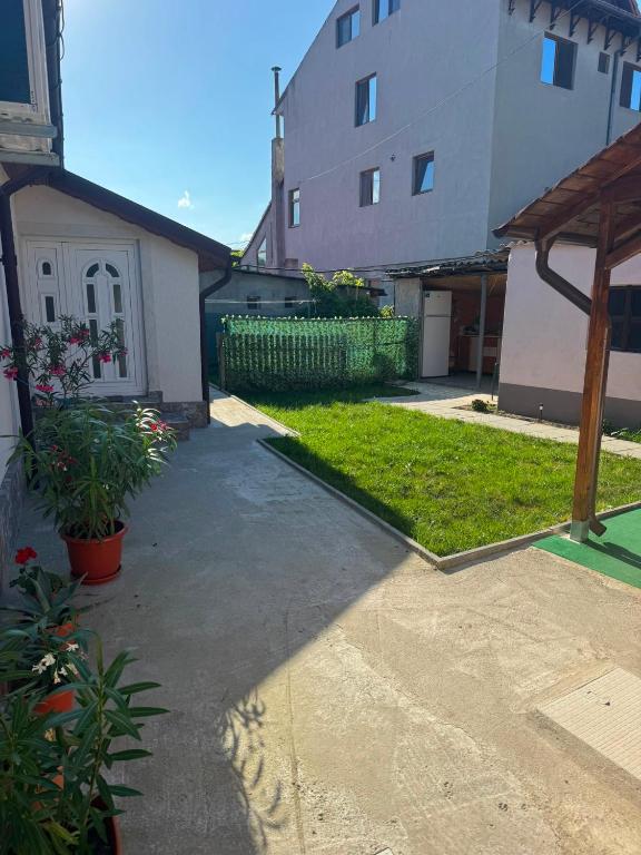 a walkway leading into a yard with a building at Casa Hax Mangalia in Mangalia
