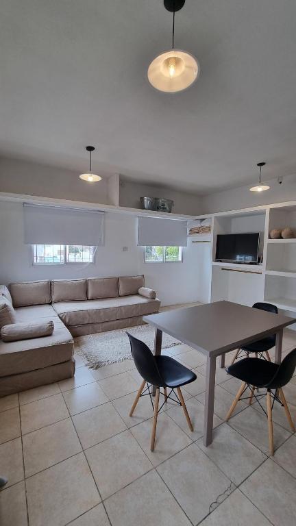 a living room with a table and a couch at Los Olivos in San Luis